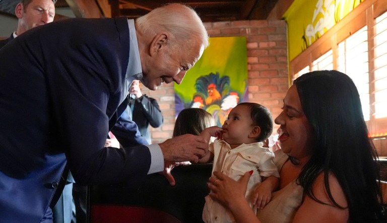 Biden walks offstage during campaign stop to play with baby