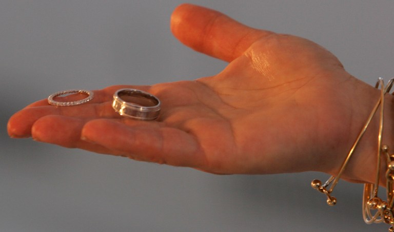 A marriage official offers a couple their rings during their wedding at the Empire State Building in New York, Wednesday Feb. 14, 2007. Cheating on your spouse is illegal in New York — but the state might soon change that. A bill working its way through the New York Legislature could repeal a more than century old law that makes adultery a crime.