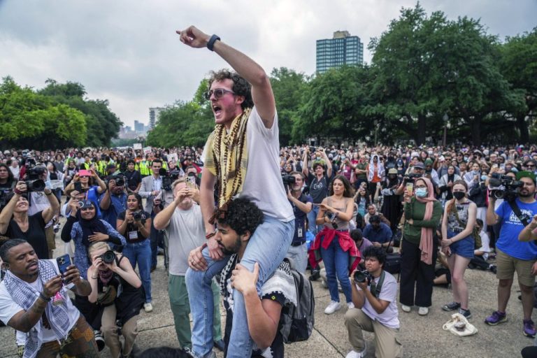 Ammer Qaddumi, one of the protesters arrested on Wednesday, April 24, 2024, participates in a chant outside the Main Building on campus. Professors, students, and supporters of UT-Austin demonstrate on campus on Thursday, April 25, 2024, in Austin. (Ricardo B. Brazziell/Austin American-Statesman via AP)