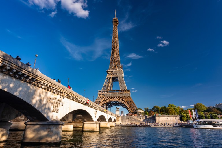 Eiffel Tower by the Seine River in Paris at summer.