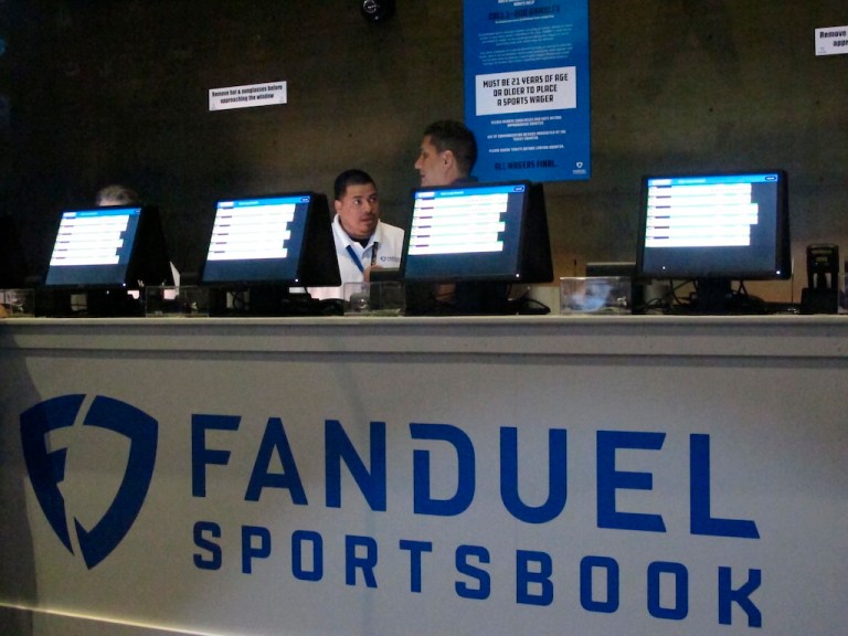 This July 14, 2018, file photo shows workers at the FanDuel sports book at the Meadowlands Racetrack in East Rutherford, New Jersey, preparing to take bets moments before it opened.