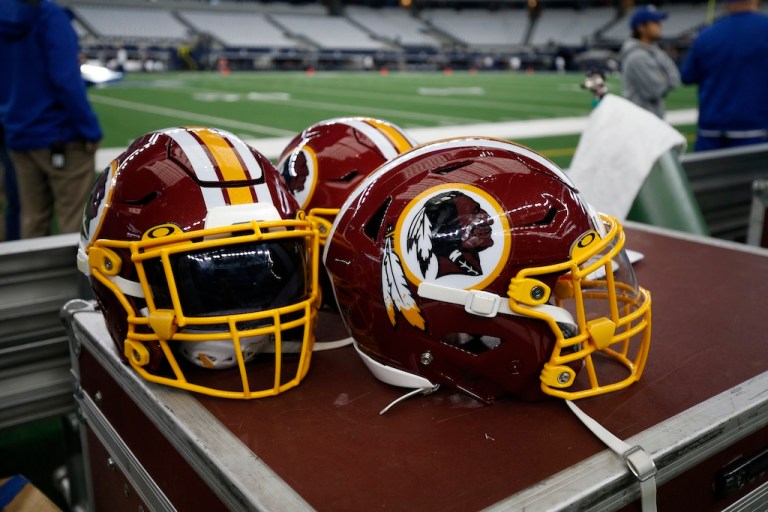 Washington Redskins helmets are seen on the sideline before an NFL football game between the Dallas Cowboys and the Washington Redskins in Arlington, Texas, Sunday, Dec. 15, 2019.