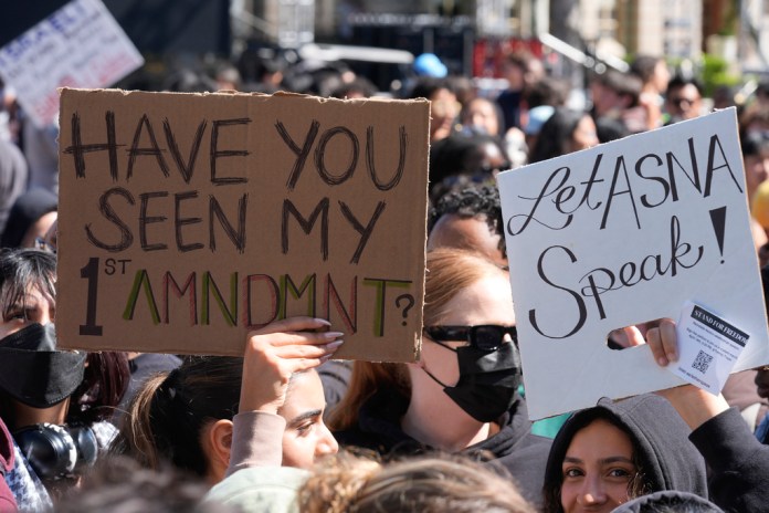 Students carrying signs protest a canceled commencement speech by its 2024 valedictorian who has publicly supported Palestinians on the campus of University of Southern California on Thursday, April 18, 2024. USC was citing security concerns, in a rare decision that was praised by several pro-Israel groups and lambasted by free speech advocates and the country's largest Muslim civil rights organization.