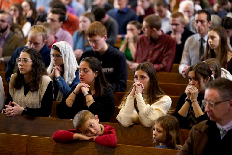 Catholics pray during Mass at Benedictine College, Sunday, Dec. 3, 2023, in Atchison, Kansas.