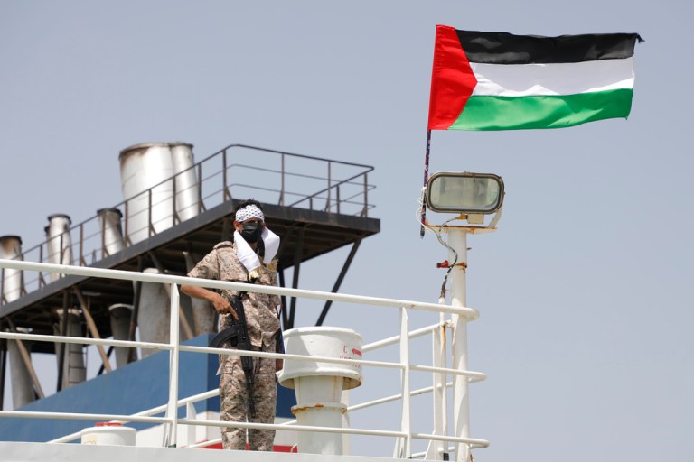 A Houthi soldier stands on board of the Israeli Galaxy ship, which was seized by the Houthis, in the port of Saleef near Hodeidah, Yemen, Sunday, May 12, 2024.