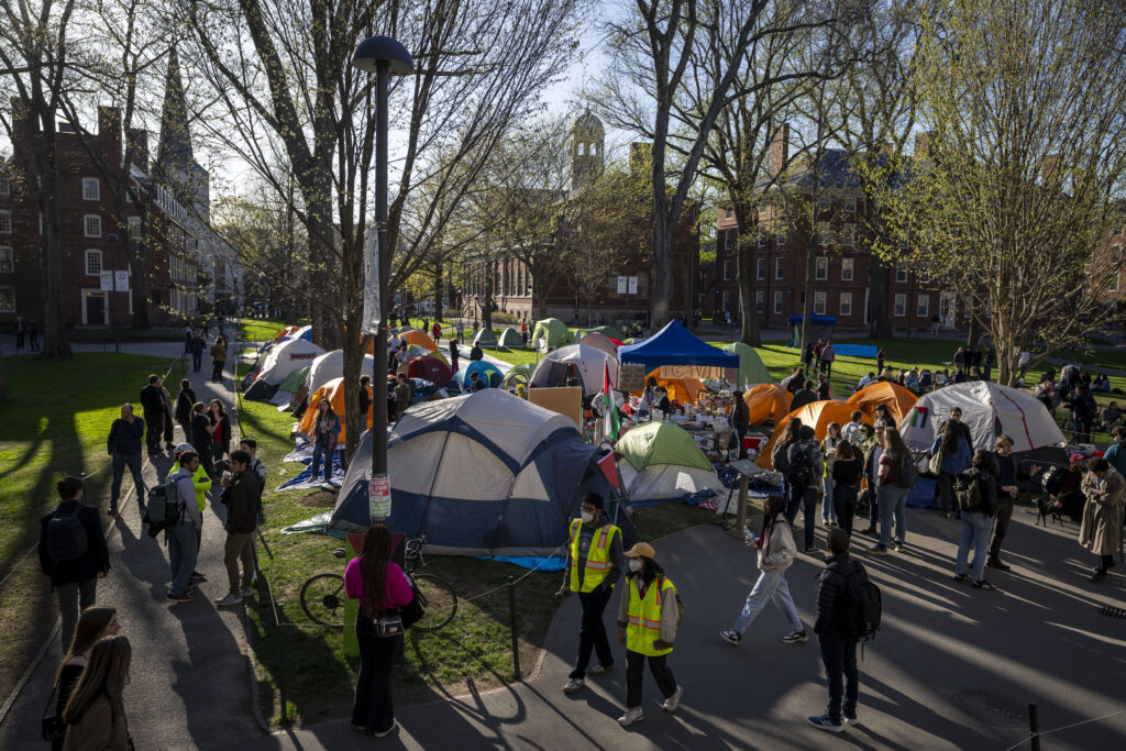 Students protesting against the war in Gaza, and passersby walking through Harvard Yard, are seen at an encampment at Harvard University in Cambridge, Mass., on April 25, 2024. Participants at the Harvard encampment protesting the war between Israel and Hamas announced they were voluntarily ending their occupation of Harvard Yard. The student protest group said in a statement that the encampment “outlasted its utility with respect to our demands,” and interim Harvard University President Alan Garber agreed to pursue a meeting between those involved in the protest and university officials.