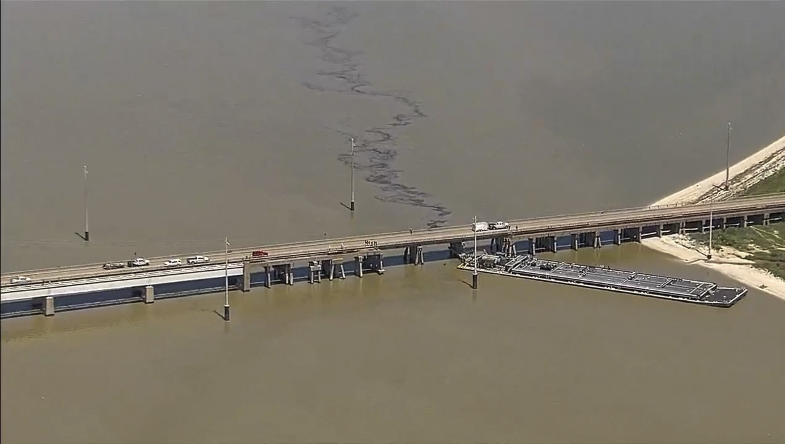 Texas bridge partially collapses after barge rams into it and causes oil spill
