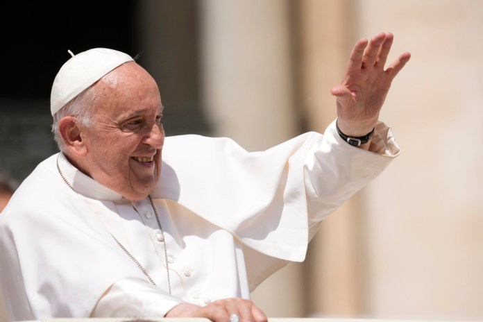Pope Francis waves to faithful at the end of his weekly general audience in St. Peter's Square at the Vatican, Wednesday, May 22, 2024.