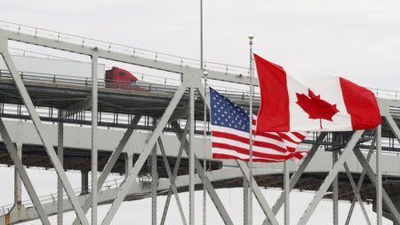 A truck crosses the Blue Water Bridge into Port Huron, Mich., from Sarnia, Ontario Wednesday, March 18, 2020. The Canada-U.S. border will be closed to non-essential traffic in both directions "by mutual consent," the leaders of both countries confirmed Wednesday as efforts across the continent to contain COVID-19. (AP Photo/Paul Sancya)
