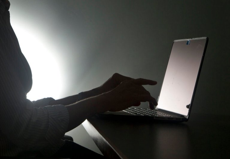 In this Dec. 12, 2016, file photo illustration, a person types on a laptop in Florida. Riviera Beach, Fla., agreed to pay $600,000 in ransom to hackers who took over its computer system, the latest in thousands of attacks worldwide aimed at extorting money from governments and businesses. Spokeswoman Rose Anne Brown said Wednesday, June 19, 2019, that the city of 35,000 residents has been working with outside security consultants, who recommended the ransom be paid.