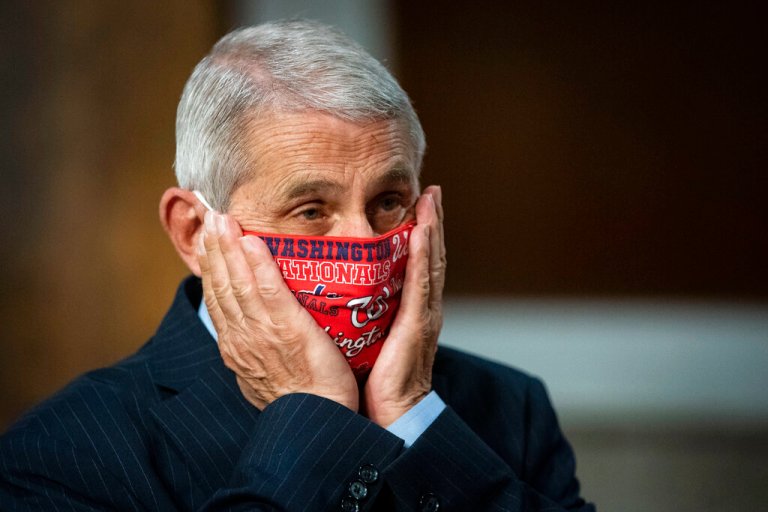 Dr. Anthony Fauci, director of the National Institute of Allergy and Infectious Diseases, adjusts his protective face mask as he arrives for a Senate Health, Education, Labor, and Pensions Committee hearing on Capitol Hill in Washington, Tuesday, June 30, 2020.