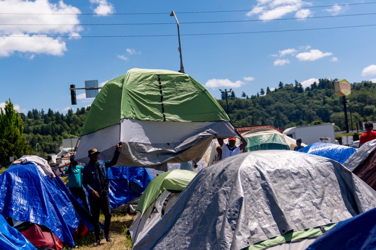 Asylum seekers camped out next to Kent freeway demanding housing