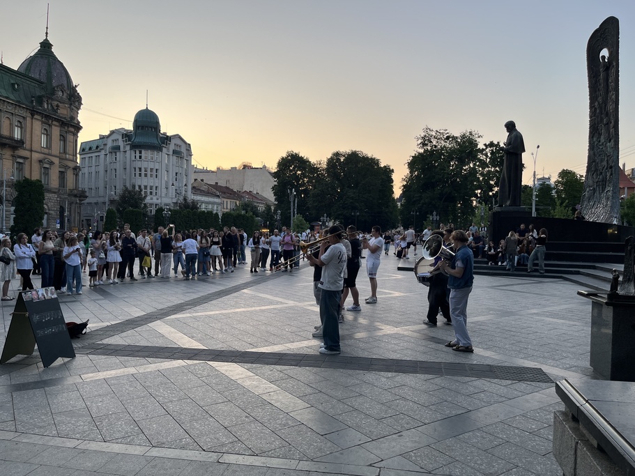 The Royal Brass Band, a group of young musicians, performs for an audience of passersby at near the Taras Shevchenko Monument in Lviv