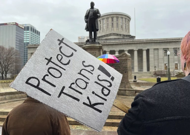 Demonstrators advocating for transgender rights and healthcare stand outside of the Ohio Statehouse on Jan. 24, 2024, in Columbus, Ohio. The rights of LGBTQ+ students will be protected by federal law and victims of campus sexual assault will gain new safeguards under rules finalized Friday, April19, 2024, by the Biden administration. Notably absent from Biden’s policy, however, is any mention of transgender athletes. (AP Photo/Patrick Orsagos, File)