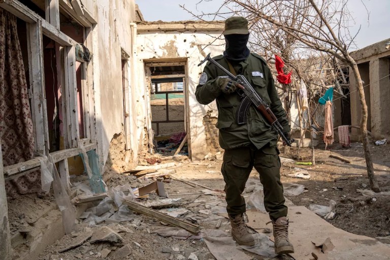 A Taliban fighter checks an Islamic State group house destroyed in the ongoing conflict between the two in Kabul, Afghanistan, Tuesday, Feb. 14, 2023. Zabihullah Mujahid, senior Taliban government spokesman, said the raid in the capital city on Monday night targeted IS militants who organized recent attacks in Kabul.