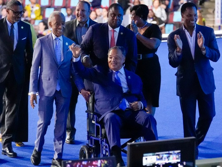Rev. Jesse Jackson waves during the Democratic National Convention Monday, Aug. 19, 2024, in Chicago. (AP Photo/Charles Rex Arbogast)