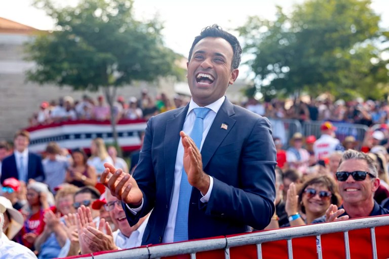 Vivek Ramaswamy laughs as he listen as Republican presidential candidate former President Donald Trump speaks at a campaign event Tuesday, June 18, 2024, in Racine, Wis. (AP Photo/Jeffrey Phelps)