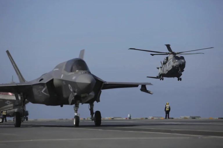 Military personnel direct F-35 jets and helicopters on the deck of the aircraft carrier HMS Queen Elizabeth as it participates in the NATO Steadfast Defender 2021 exercise off the coast of Portugal, Thursday, May 27, 2021.