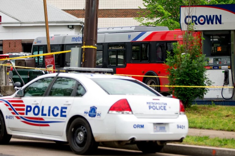 Police work at a crime scene after authorities say a man attacked a bus driver, stole the bus, then struck and killed a man after the bus jumped a curb at a gas station at the corner of Helen Burroughs Avenue and Minnesota Avenue in Northeast Washington, D.C., Tuesday, May 3, 2016.