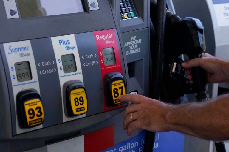 A customer pumps gas at an Exxon gas station, Tuesday, May 10, 2022, in Miami.