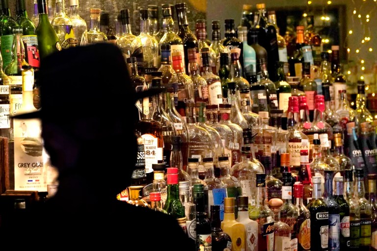 FILE - Bottles of alcohol sit on shelves at a bar in Houston on June 23, 2020. Moderate drinking was once thought to have benefits for the heart, but better research methods starting in the 2010s have thrown cold water on that.
