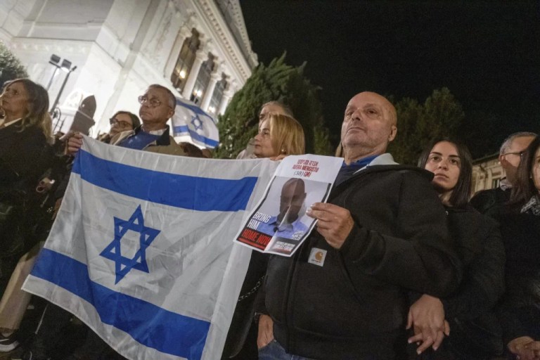 Supporters hold the flag of Israel