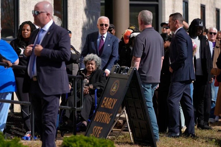 Biden votes early in Delaware and waits in line with colorful Trump supporter