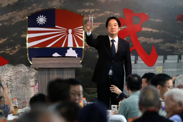 Taiwanese President Lai Ching-te cheers during a ceremony commemorating the 66th anniversary of a deadly attack by China on Kinmen Island, Taiwan, Friday, Aug. 23, 2024.