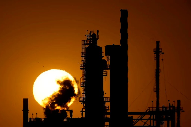 The CHS oil refinery is silhouetted against the setting sun, Saturday, Sept. 28, 2024, in McPherson, Kansas.