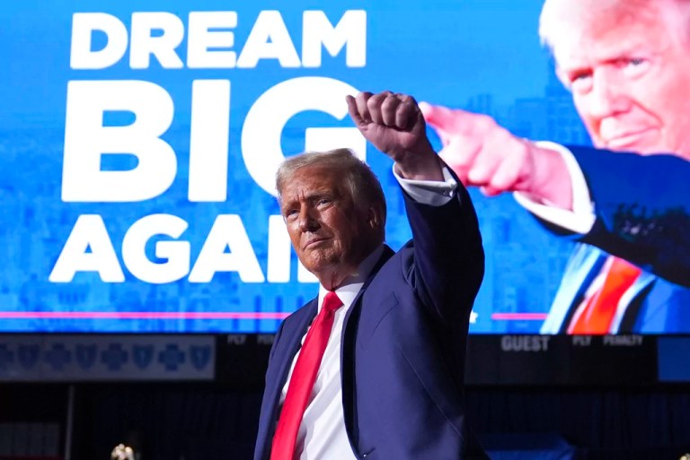 President Donald Trump gestures at a campaign rally at Van Andel Arena on Tuesday, Nov. 5, 2024, in Grand Rapids, Michigan.