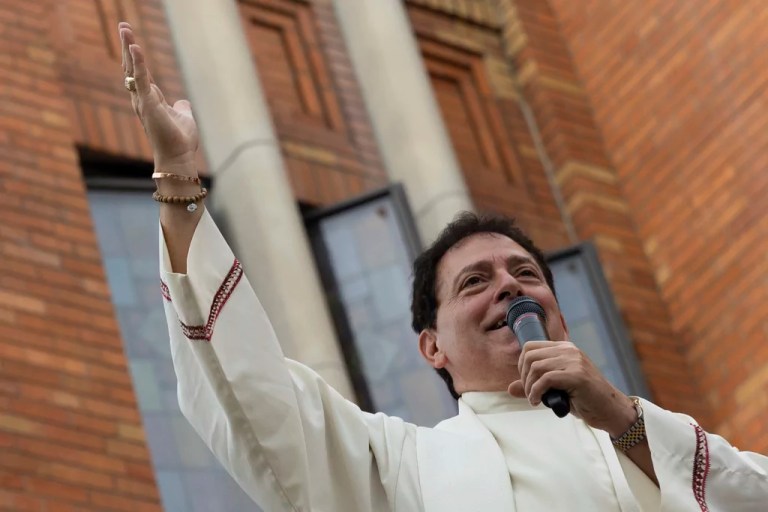Former pastor of Shrine Church of Our Lady of Mount Carmel Monsignor Jamie Gigantiello speaks with parishioners, Saturday, July 16, 2022, in the Brooklyn borough of New York.