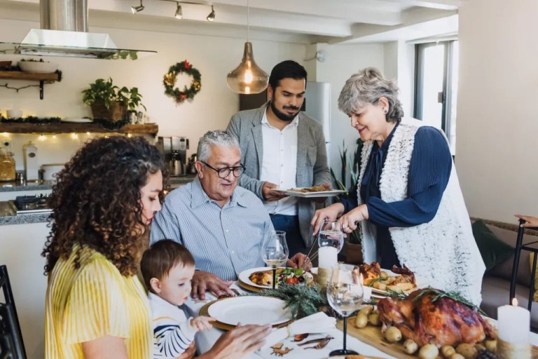A family eats Thanksgiving dinner