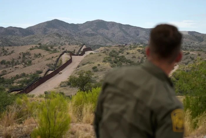 Border patrol agent Pete Bidegain looks from a hilltop on the U.S. side of the US-Mexico border in Nogales, Ariz., June 25, 2024. (AP Photo/Jae C. Hong, Pool, File)