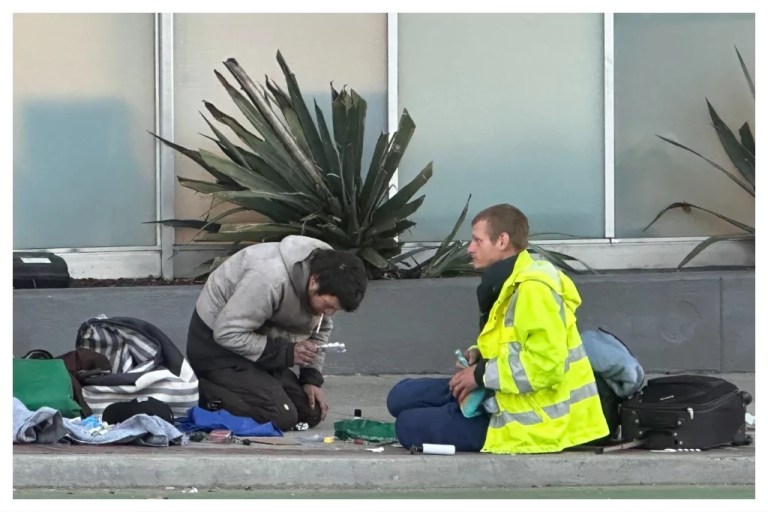 Two people on the streets of San Francisco do drugs openly, Oct. 30, 2024.