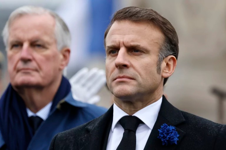French President Emmanuel Macron, right, and Prime Minister Michel Barnier stand at attention during commemorations marking the 106th anniversary of the Nov. 11, 1918, Armistice, which ended World War I, at the Arc de Triomphe in Paris, Monday, Nov. 11, 2024.