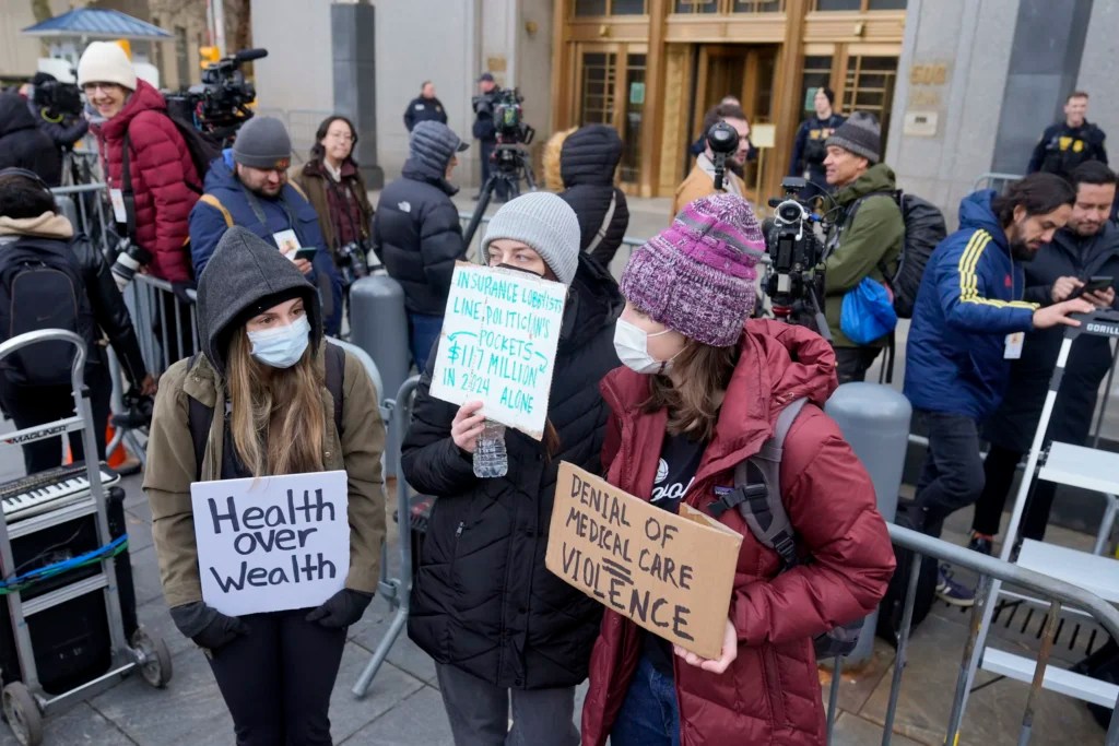 Demonstrators stand outside Manhattan federal court shortly after Luigi Mangione, the suspected killer of UnitedHealthcare CEO Brian Thompson, arrived for a hearing, Thursday, Dec. 19, 2024, in New York.