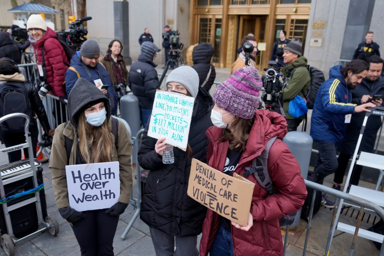 Demonstrators stand outside Manhattan federal court shortly after Luigi Mangione, the suspected killer of UnitedHealthcare CEO Brian Thompson, arrived for a hearing, Thursday, Dec. 19, 2024, in New York.
