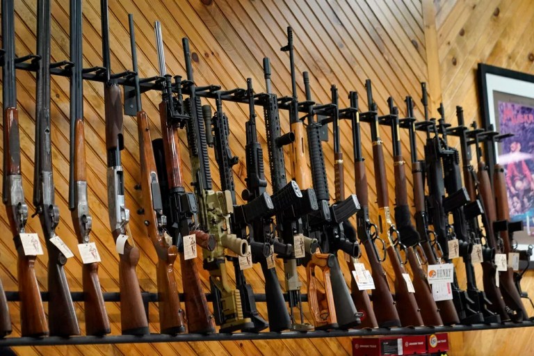 Various guns are displayed at a store on July 18, 2022, in Auburn, Maine. Most adults in the United States think gun violence is increasing nationwide and want to see gun laws made stricter, according to a new poll that finds broad public support for a variety of gun restrictions. The poll comes from the University of Chicago Harris School of Public Policy and the Associated Press-NORC Center for Public Affairs Research.