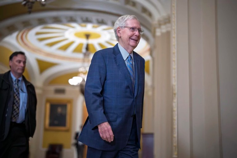 Senate Minority Leader Mitch McConnell (R-KY) smiles as he walks to join other Republicans who will vote to replace him with a new leader, at the Capitol in Washington, Wednesday, Nov. 13, 2024.