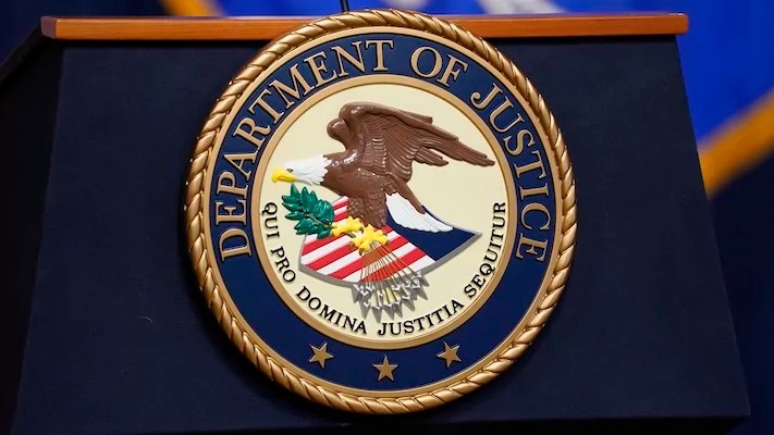 The seal for the Department of Justice is displayed on a podium before a news conference at the DOJ in Washington, Thursday, April 13, 2023.