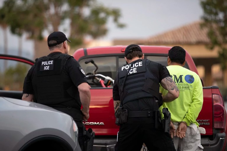 In this July 8, 2019, photo, a U.S. Immigration and Customs Enforcement (ICE) officers detain a man during an operation in Escondido, Calif.