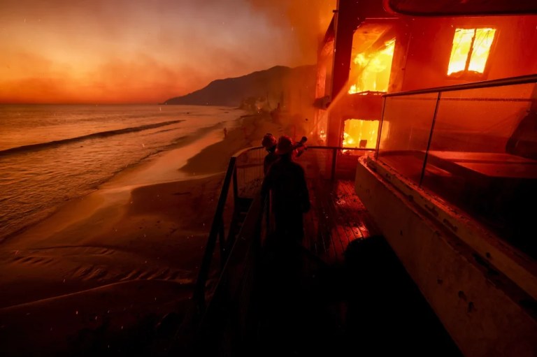 Firefighters work from a deck.