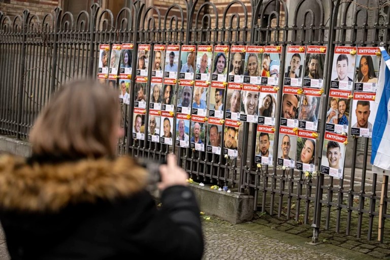 A woman takes pictures of the hostages kidnapped by Hamas at the fence in front of the New Synagogue Berlin on Jan. 16, 2025 in Tel Aviv, Israel.