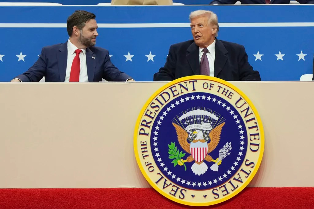 President Donald Trump, right, and Vice President JD Vance, sit at an indoor Presidential Inauguration parade event in Washington, Monday, Jan. 20, 2025.