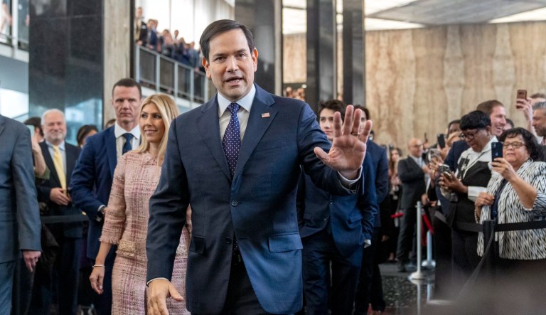 Secretary of State Marco Rubio greets people as he arrives to speak to State Department staff followed by his family, at the State Department, Tuesday, Jan. 21, 2025, in Washington.