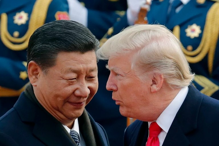 President Donald Trump, right, talks with Chinese President Xi Jinping during a welcome ceremony at the Great Hall of the People in Beijing, Nov. 9, 2017.