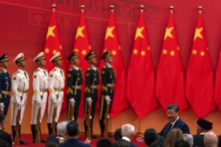 Chinese President Xi Jinping, right, invites winners of the national medals to join him after a ceremony held in the Great Hall of the People in Beijing, Sunday, Sept. 29, 2024.