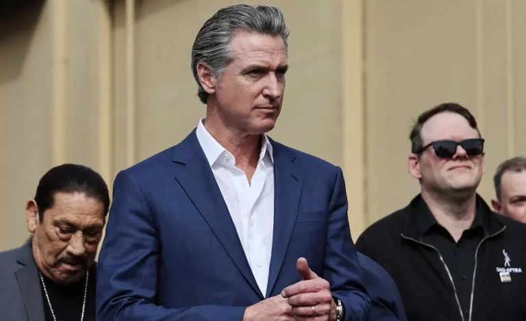 Gov. Gavin Newsom (D-CA) stands with actor Danny Trejo, left, and SAG-AFTRA National Executive Director Duncan Crabtree-Ireland at a press conference at Raleigh Studios to unveil a vast expansion of California’s Film and Television Credit Program, Oct. 27, 2024, in Los Angeles, California.