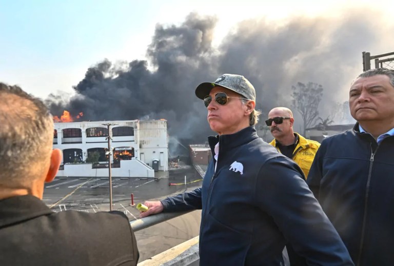 Gov. Gavin Newsom (D-CA), left, surveys damage in Pacific Palisades with CalFire's Nick Schuler, center, and State Senator Alex Padilla during the Palisades Fire on Wednesday, January 8, 2025, in Pacific Palisades, California.