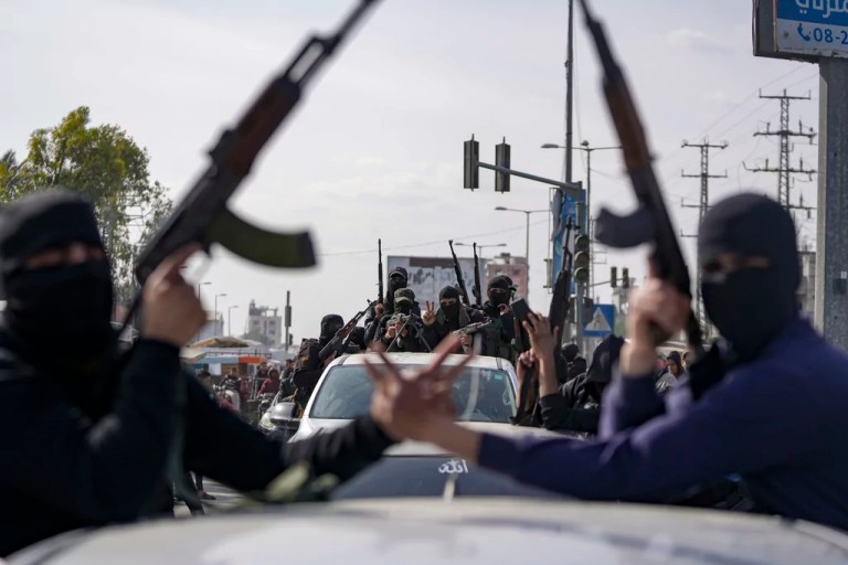 Members of the Izzedine al-Qassam Brigades, the armed wing of the Palestinian group Hamas, take part in a parade as they celebrate a ceasefire agreement between Hamas and Israel in Deir al-Balah, Gaza Strip